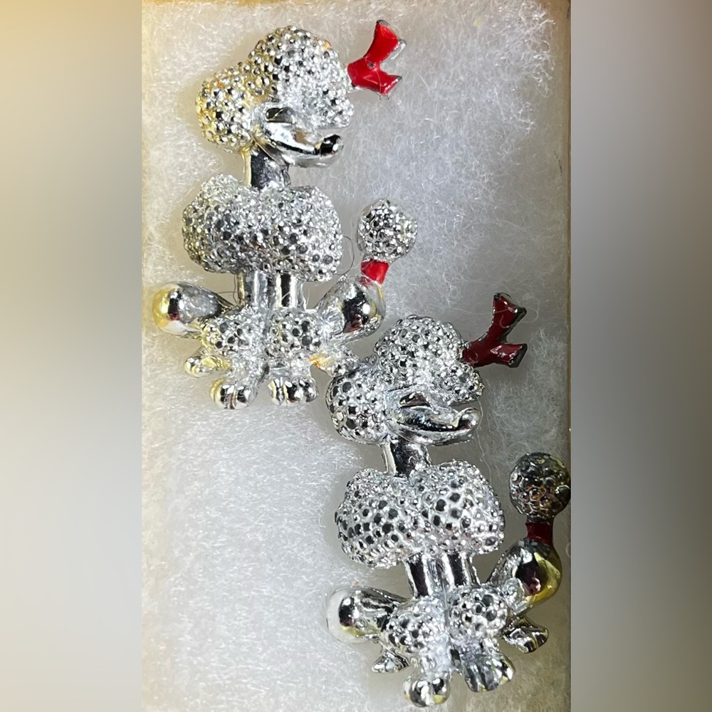 Silver plated French Poodle brooches with red enamel bows. Set of two brooches.